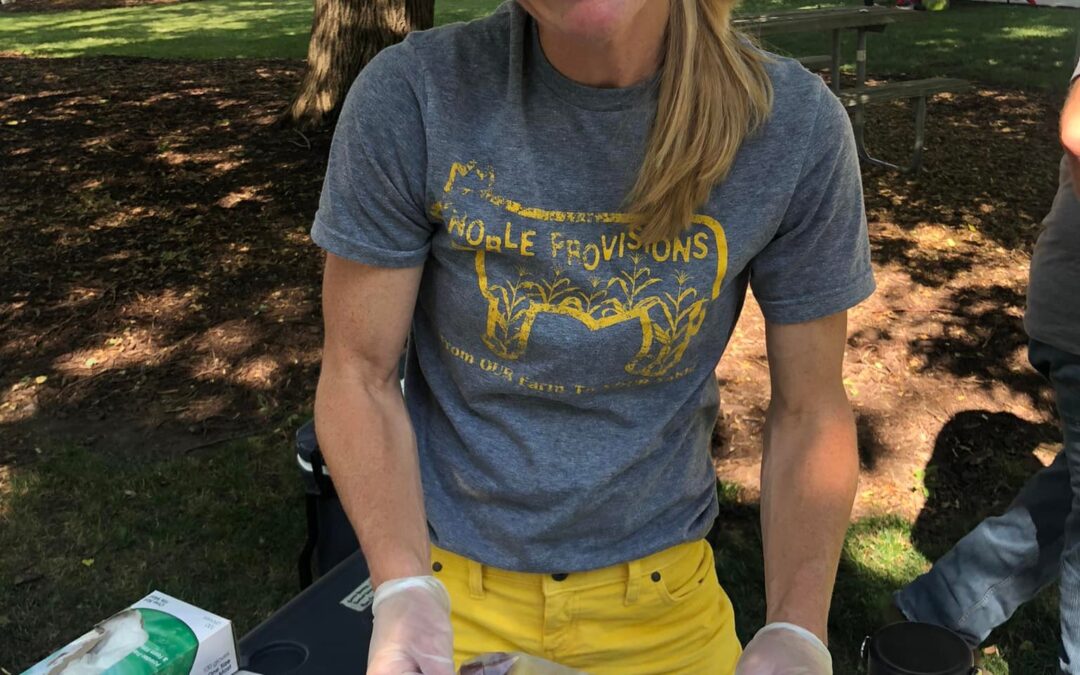 Maggie Mueller of Noble Provisions shares beef stick samples at Produce in the Park